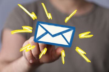Hand holding digital email icon,new message alert concept.