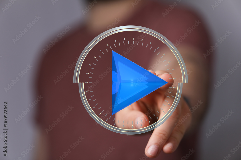 Poster hand interacts with a digital play button, symbolizing media playback or starting a project.
