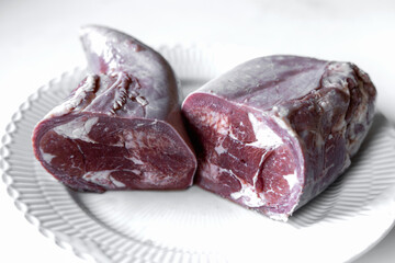 Boiled beef tongue on white serving plate