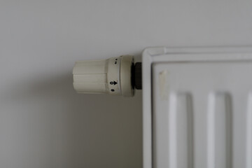 High-quality close-up image of a white radiator thermostat knob. Perfect for home improvement, interior design, and energy efficiency concepts.