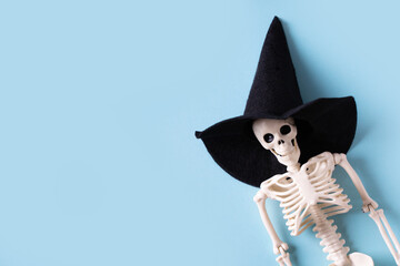 Halloween Skeleton in Witch Hat on Blue Background