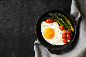 Fried Egg with Asparagus and Cherry Tomatoes in Cast Iron Skillet