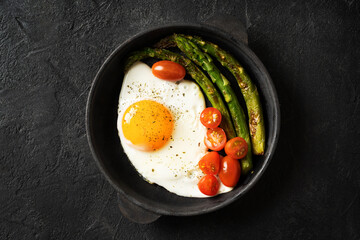 Flat Lay of Egg with Asparagus and Tomatoes in Skillet