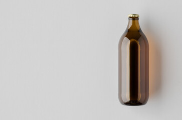 Mockup of a glass beer bottle on a neutral background with blank copyspace.