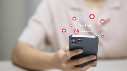 Woman holding smartphone with social media followers and likes notification, online engagement and digital community concept