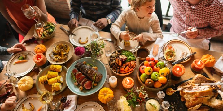 Diverse family enjoying a Thanksgiving festive meal. Laughter and food shared on a table. Thanksgiving celebration with family, delicious and joyful. Diverse family enjoy Thanksgiving meal together
