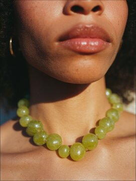 Editorial portrait of Italian woman with Mediterranean beauty and jewelry. Close-up photography with rustic background, inspired by Italian fashion and lifestyle