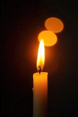 Fototapeta premium Close-up of a flickering candle flame, warm orange and yellow hues dancing in the air, creating a mesmerizing, gentle light Perfect for themes of peace, tranquility, and hope , serene, meditation
