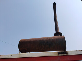 Modern diesel generator with visible exhaust smoke emitting from top vent during power generation...