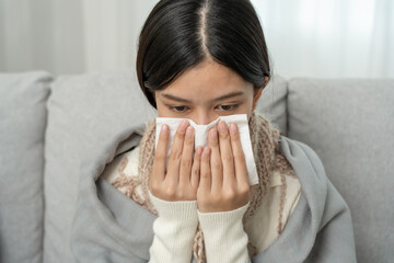 sick woman with a headache sitting under blanket, female sneezing and runny nose with seasonal influenza, allergic, high fever and influenza, resting, virus, coronavirus, feel illness, respiratory