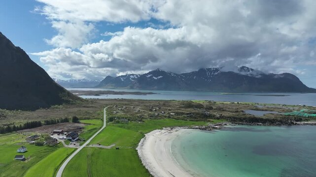 Hov Beach on Gimsoy island, Lofoten, Norway, establishing aerial flight over shoreline, upscale rental cabins.