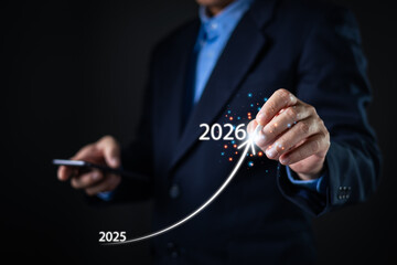A businessman in a suit points to a glowing rising arrow from 2025 to 2026, symbolizing growth, future planning, financial success, innovation, and upward progress in business strategy.