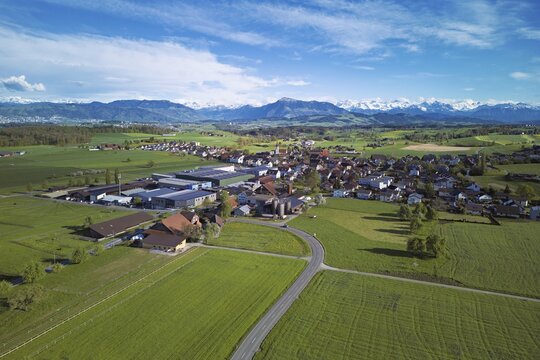 View of the village, in the foreground the industrial area, in the background the Rigi and the snow-covered Alps, Auw, Freiamt, Canton, Aargau, Switzerland