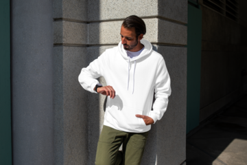 Menswear png hoodie mockup on man with green pants in the city