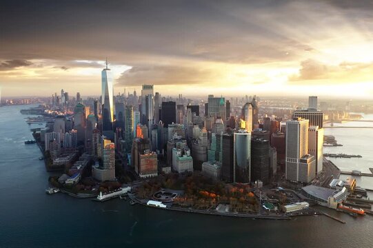 Aerial view of New York City Manhattan at sunrise - golden hour - yellow colors of sun light through buildings