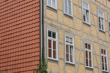 Traditional german facade with timber framing, red tiled roof and white windows