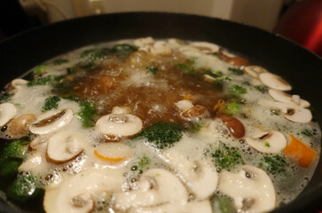 Boiling Vegetable Soup Image with Mushrooms, Broccoli and Carrots in Pot - Closeup Picture