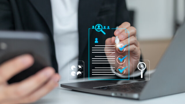 Businesswoman using laptop and smartphone with digital recruitment and HR management icons, AI technology for candidate selection, job application, and workforce