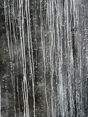 Dark weathered slate wall with white streaks and a faint marks useful background