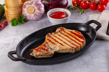 Tasty hot grilled bone steak served sauce