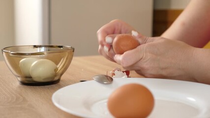 Peeling a boiled egg. Preparing dishes with eggs. - Powered by Adobe