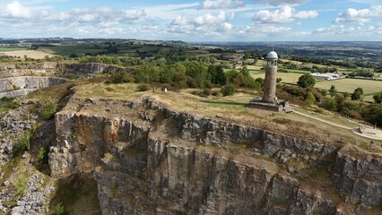 Aerial shot of Crich Memorial tower and rolling green landscape, Derbyshire Dales, England UK