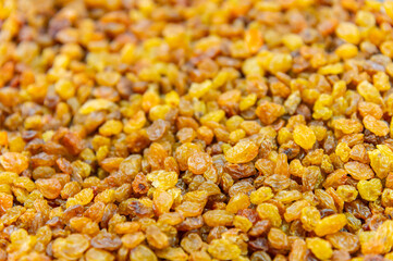 Close up of lots of golden raisins. Dried seedless grapes