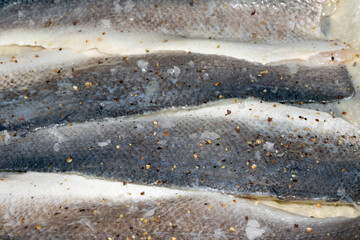 Macro close up of raw basa fish skin with scale detail ready for cooking © squeebcreative