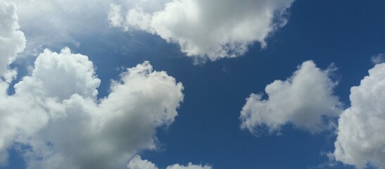 Fluffy White Clouds Against Blue Sky on a Clear Summer Day