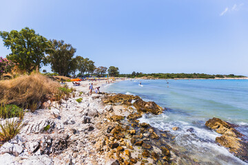 Busy Mediterranean beach paradise with families enjoying crystal clear turquoise waters, white...