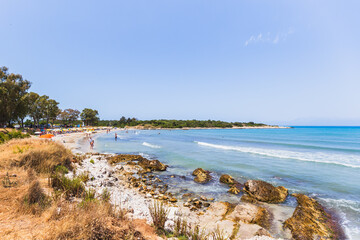 Busy Mediterranean beach paradise with families enjoying crystal clear turquoise waters, white...