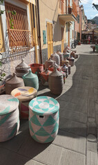 Naklejka premium Traditional woven African baskets on street of old town in Italy. Private business, market and sales. Objects for kitchen, home, handmade.