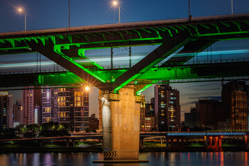 The splendid night view of Cheongdam Bridge on the Han River in Seoul, South Korea, with the subway passing over it.