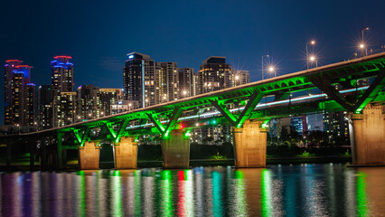 The splendid night view of Cheongdam Bridge on the Han River in Seoul, South Korea, with the subway passing over it.