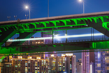 The splendid night view of Cheongdam Bridge on the Han River in Seoul, South Korea, with the subway passing over it.
