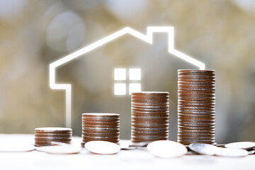 rising stacked coins with house