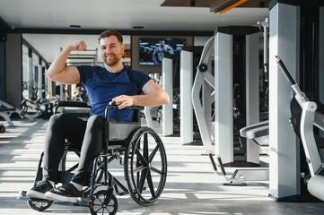 Person with disability showing muscles during rehabilitation in gym