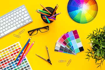 Color paint swatches and decorator or designer tools for work. Desktop flat lay, top view