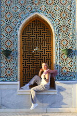 A hot summer evening in Samarkand, Uzbekistan.
Female tourist walks through the old city.
Woman...