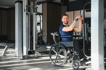 Man with disability performing rehabilitation exercises in gym using cable machine