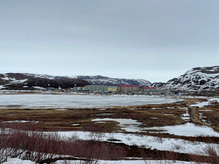 The village of Teriberka and Lake Lodeynoye at sunset in spring. Russia.