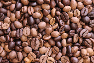 Fresh roasted aromatic arabica coffee bean smoking on rustic jute fabric round mat