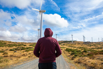 Exploring renewable energy sources at a wind farm in a scenic landscape under a vibrant sky