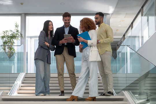 Business team discussing strategy on tablet in modern office