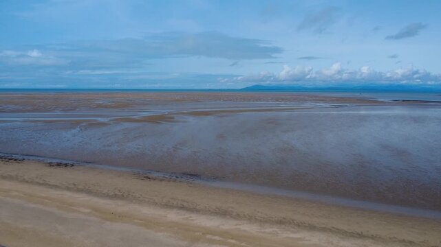aerial view of the mouth of the river Wyre in Lancashire Fleetwood at low tide with the large expanse of sand looking across to the village of Heysham and the power station in the distance