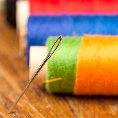 Close-up of needle and colorful sewing threads