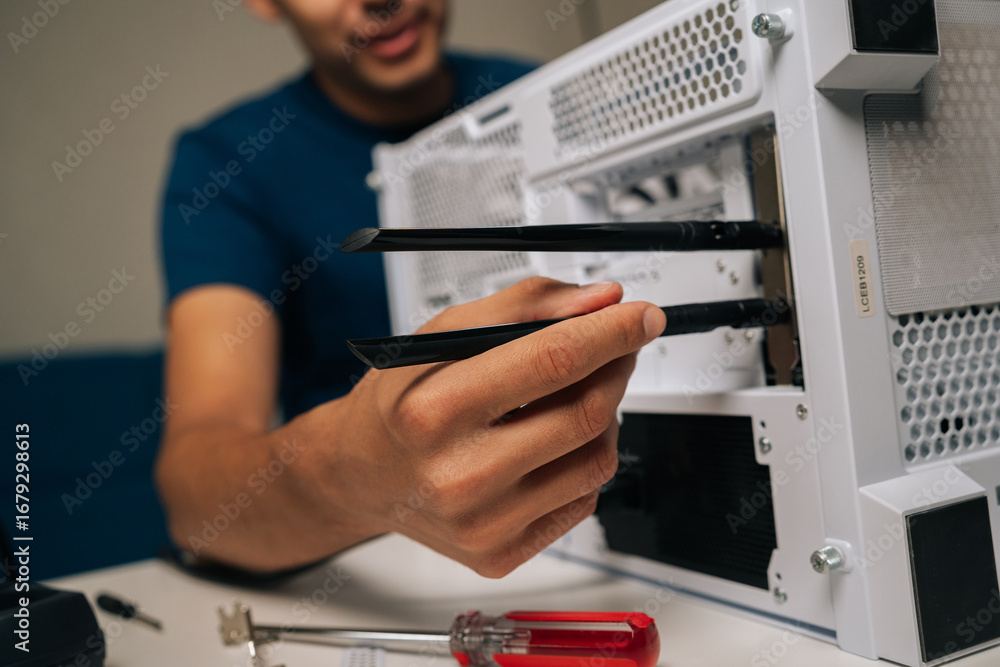 Poster cropped shot of technician installing dual-antenna wifi module inside desktop computer case, improvi