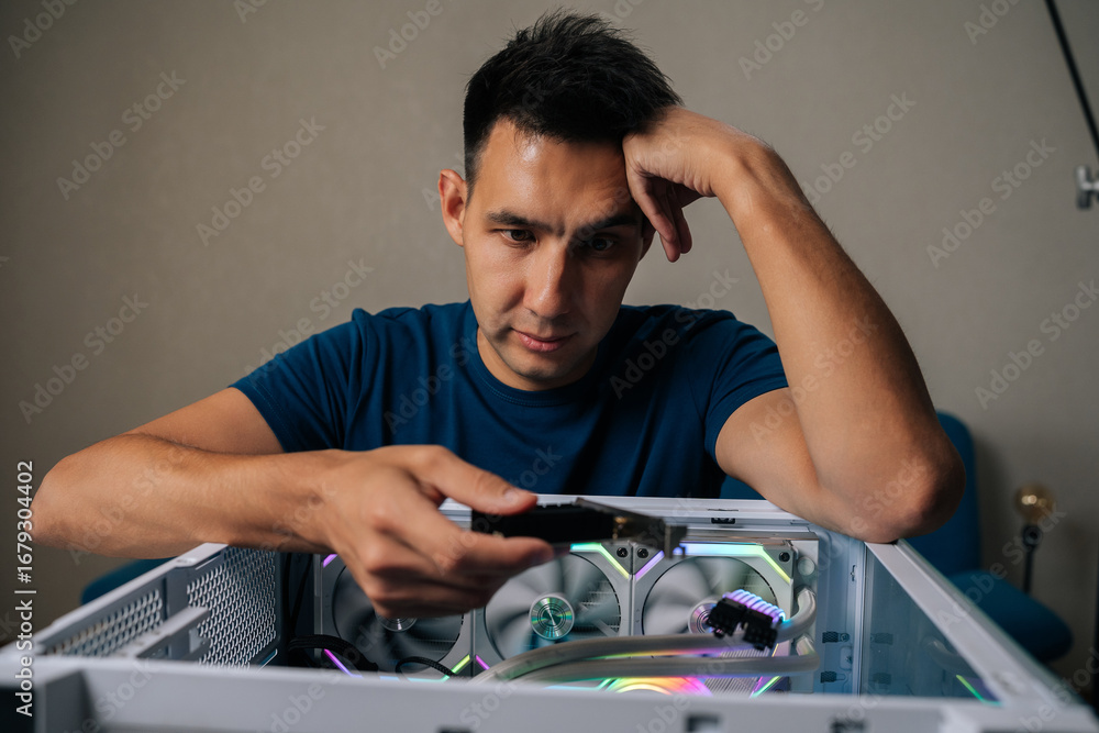 Fototapete puzzled technician upgrading desktop computer by installing wi-fi module, focusing intently on task 