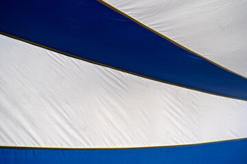 Colorful blue and white striped fabric creating a vibrant outdoor atmosphere.