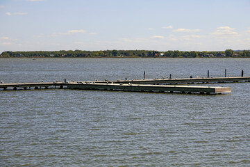 The pier on Jamno Lake in the resort town of Mielno, Poland, is empty, and several seagulls sit there
